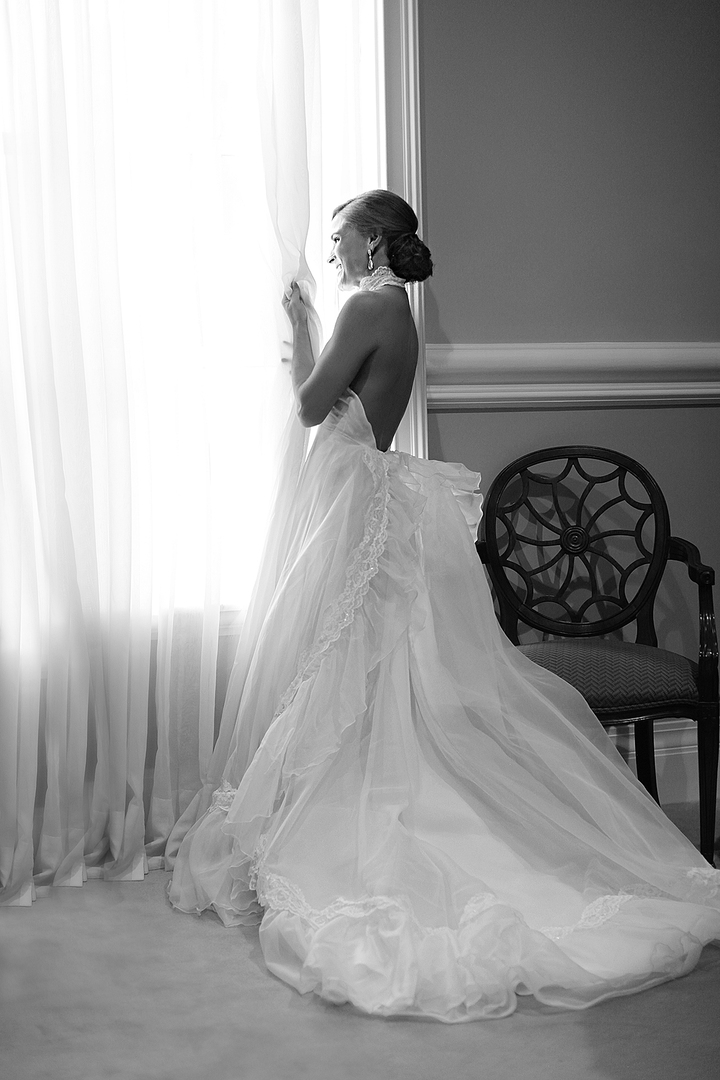 Southern bride posing in her dainty wedding dress made from her mother's wedding dress at her wedding in Monroe Louisiana