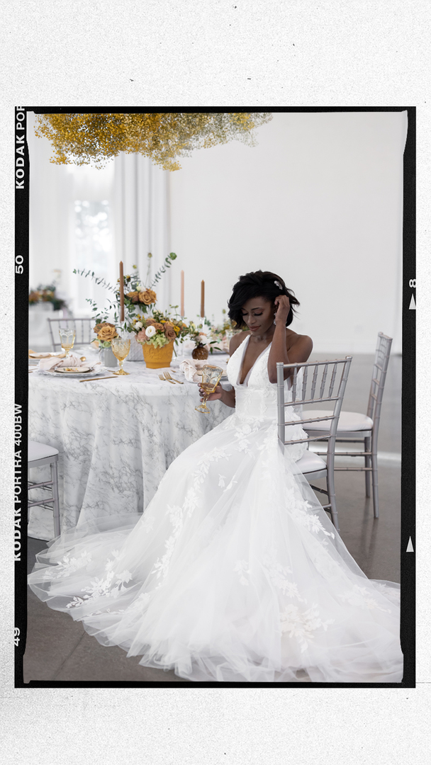 beautiful black bride in white gown sitting at a reception table during I Street Ballroom Wedding
