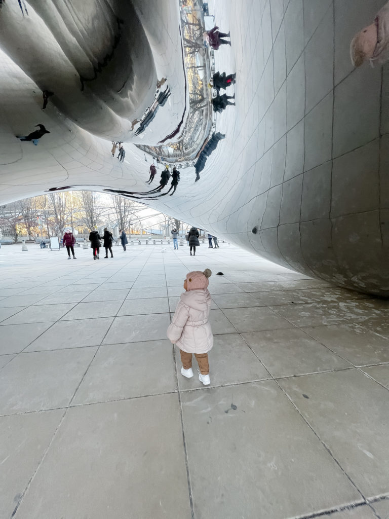 little girl under the bean at Millennium Park in Chicago