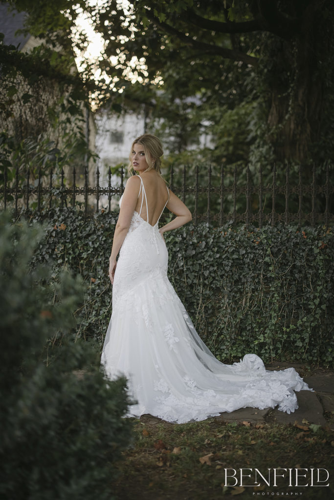 Luxury Bridal Portraits in Fayetteville Arkansas in front of an ivy wall with wrought iron fencing