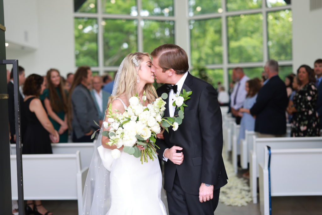 Osage House Real Wedding couple kissing in the chapel by luxury wedding photography in Northwest Arkansas
