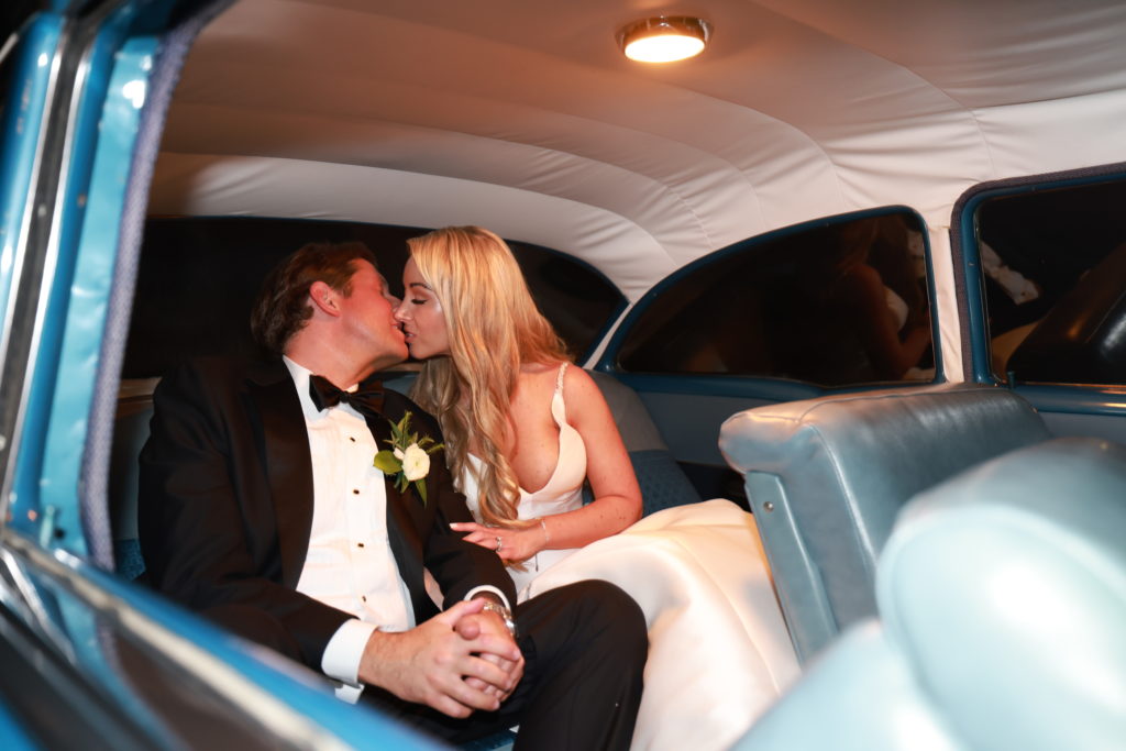 Osage House Real Wedding couple in getaway car kissing