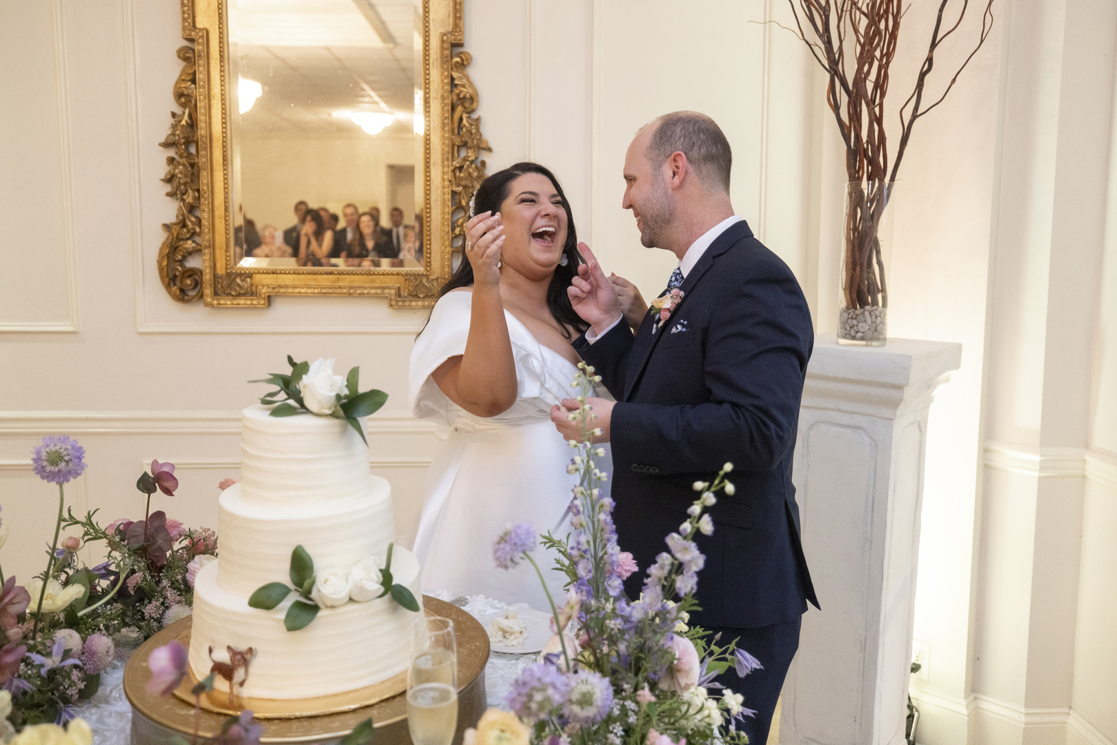 Bride and Groom cutting the cake during their wedding reception at Vintage Court in Covington LA