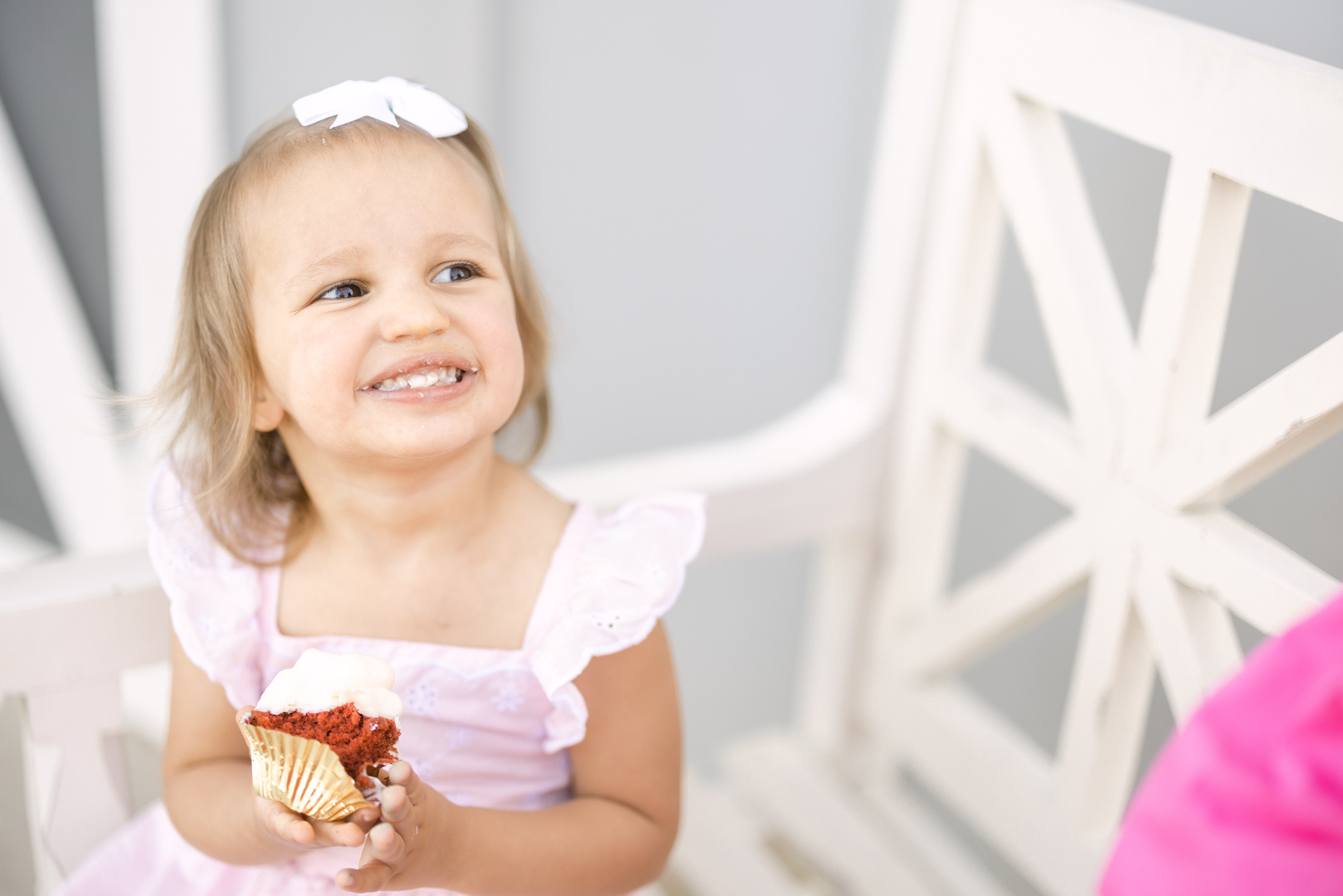 Momma's little wedding date eating a red velvet cupcake