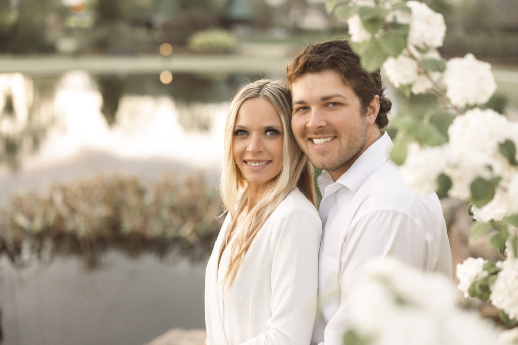 young couple hold each other during their engagement shoot in bentonville