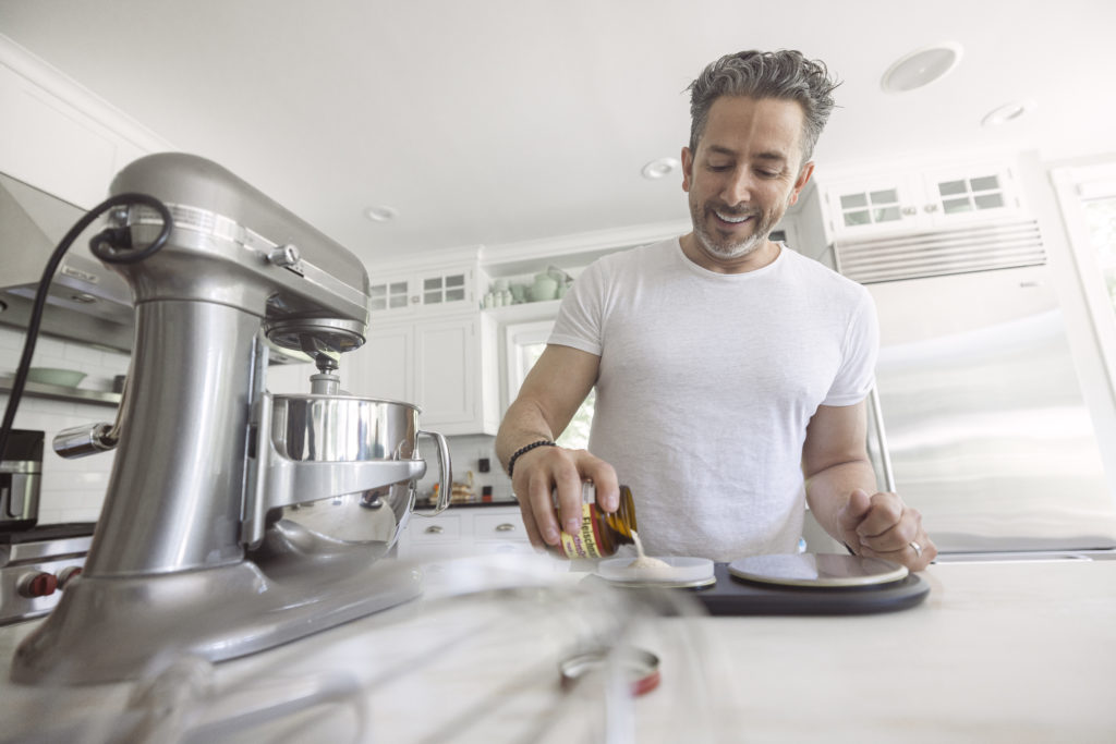 Pizza chef prepping pizza dough using a kitchenaid stand mixer