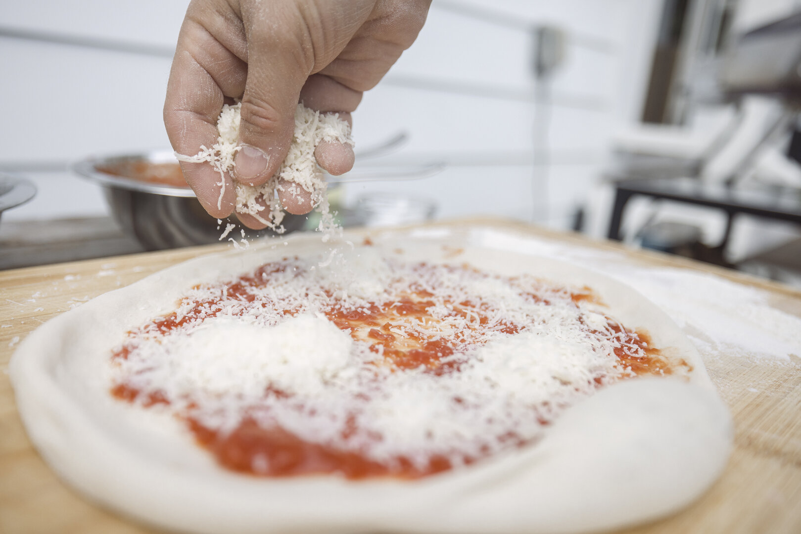 how to take great food photos for pizza party night by shooting pizza chef add grated cheese to pizza crust