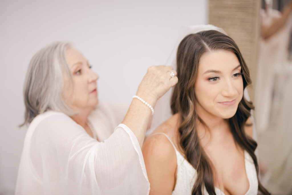 bride's mother helps her with the veil for her wedding at Kindred North