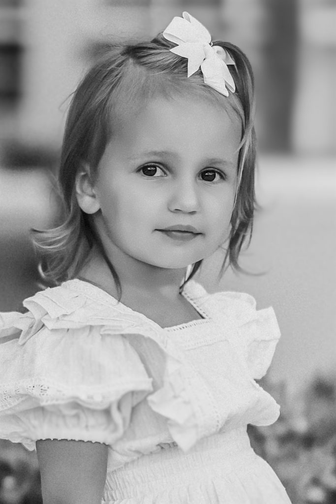 wedding pictures at the Ritz-Carlton Cancun of a flower girl dressed in white.
