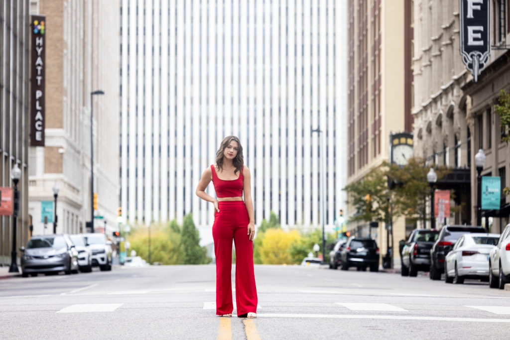 Urban Senior Pictures in Tulsa of a brunette in a red jumpsuit