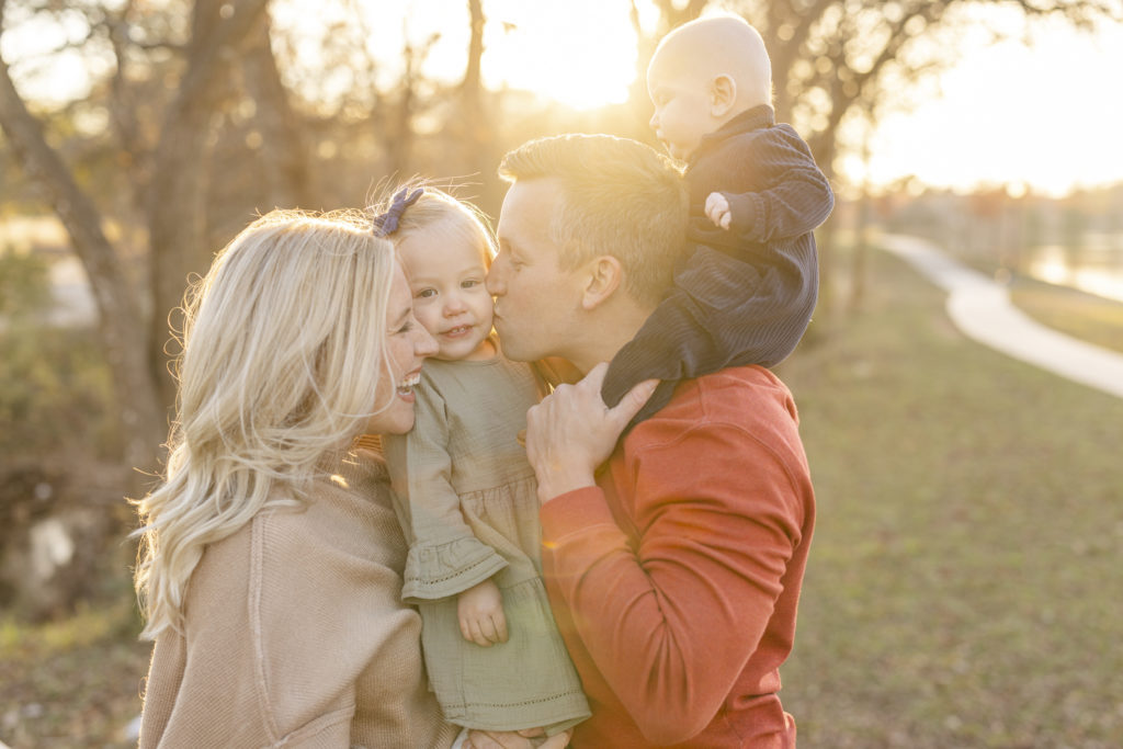 this best family portraits of 2022 nominee shows a family of 4 at golden hour using benny backlight
