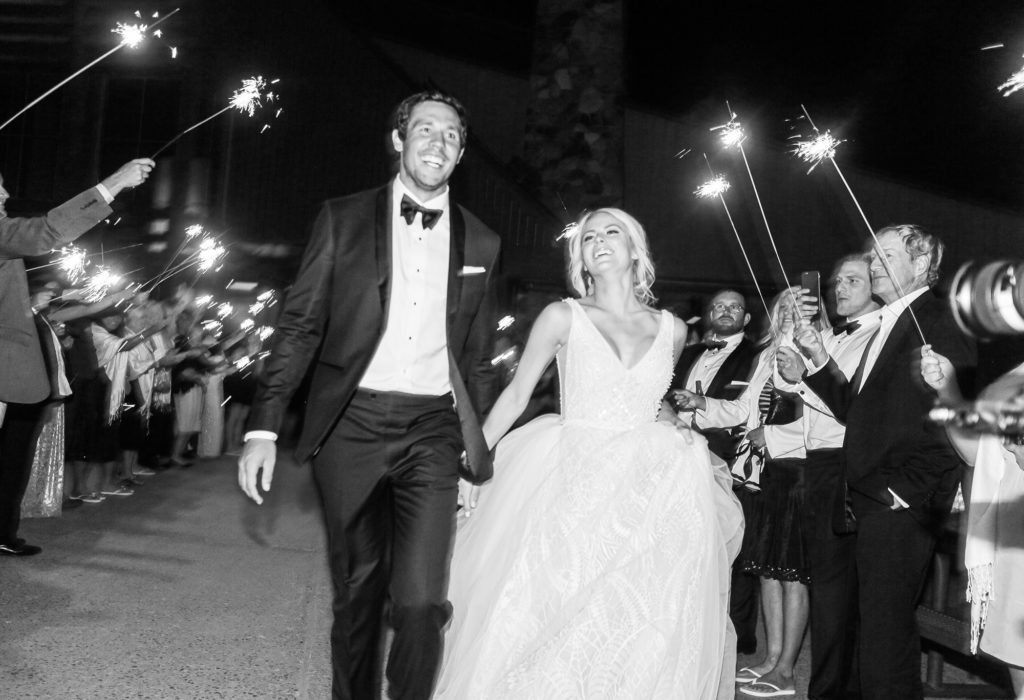 Sam Bradford leaves wedding with bride Emma Lavy at their luxury wedding at Aspen Mountain