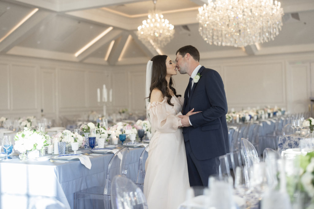 This best kisses of 2022 nominees shows a bride and groom kissing in their empty wedding reception ballroom at the Hillside Estate in DFW
