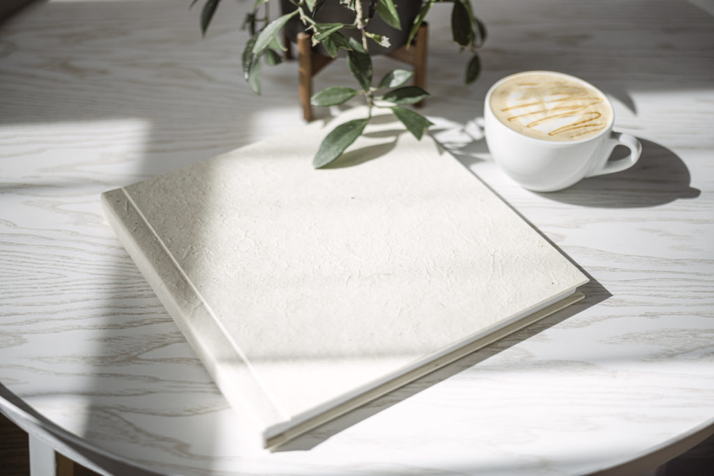 Handcrafted Bespoke Wedding Album by Benfield Photography and a cup of coffee from Onyx Coffee Lab