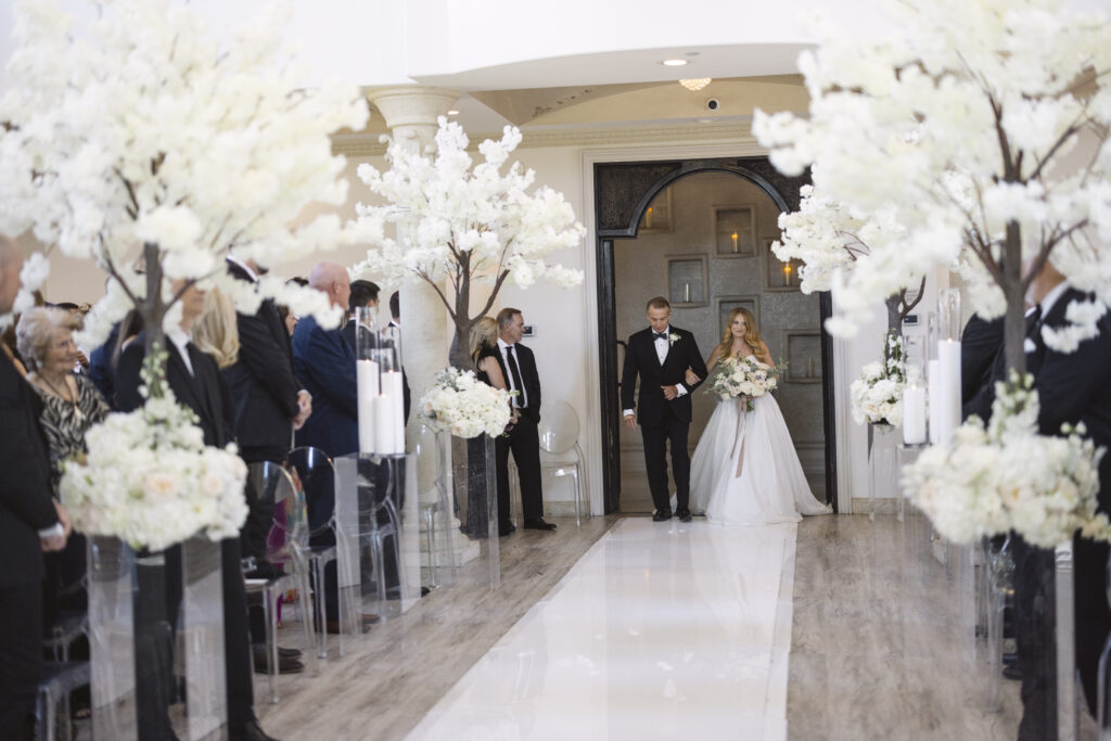 wedding at Knotting Hill Place, a bride is escorted down a perfect aisle
