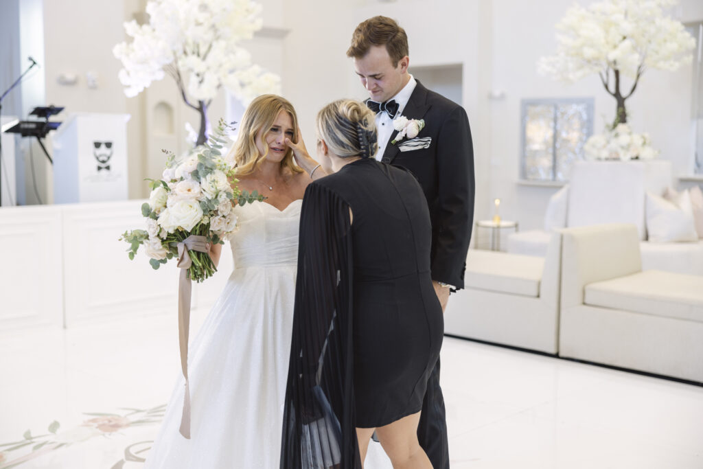 an emotional bride cries seeing her reception spaced brought to life by Hunter Orcutt at the Knotting Hill Place wedding venue in Dallas TX