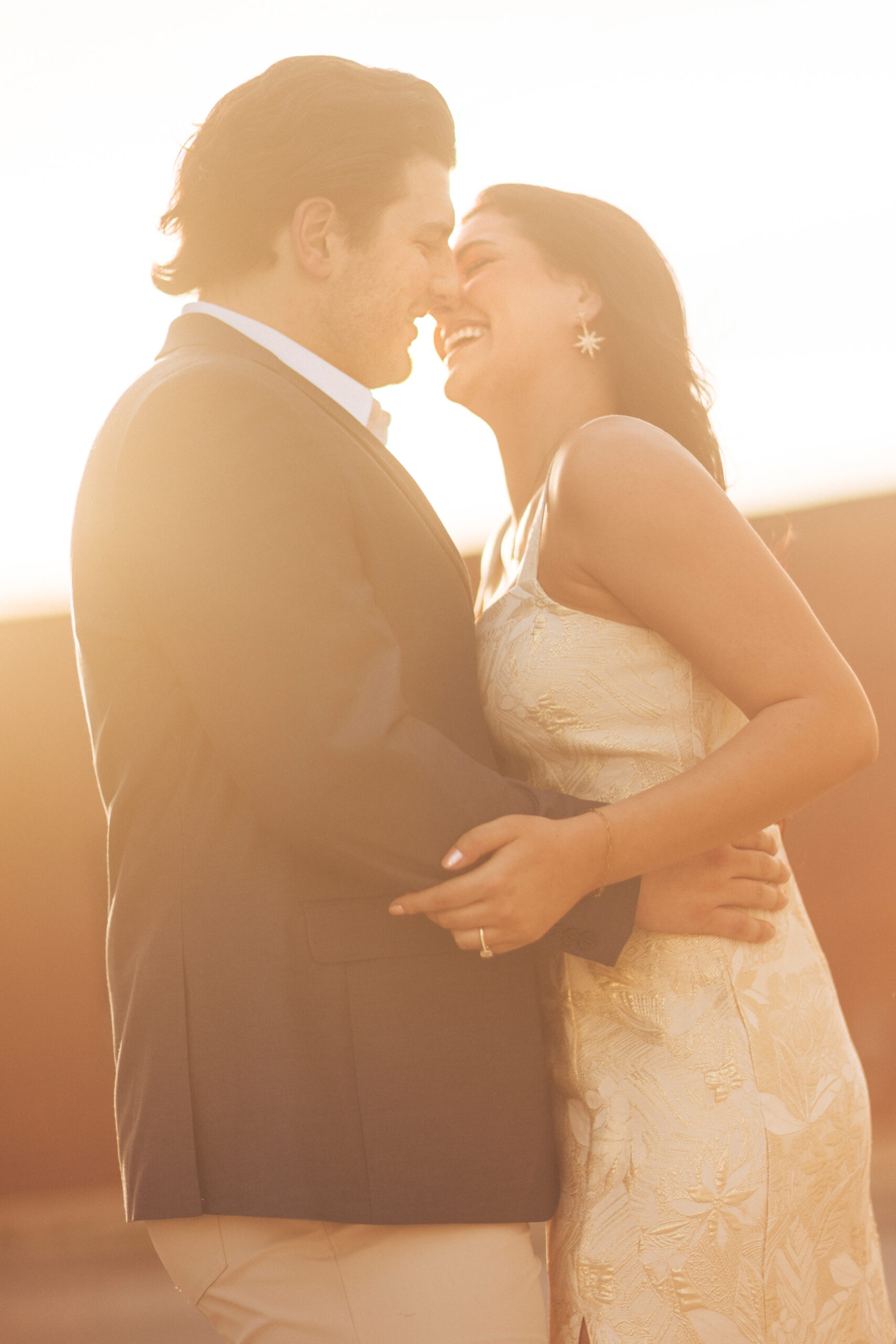 beautiful couple kissing at sunset during golden hour for their NWA Engagement Photos