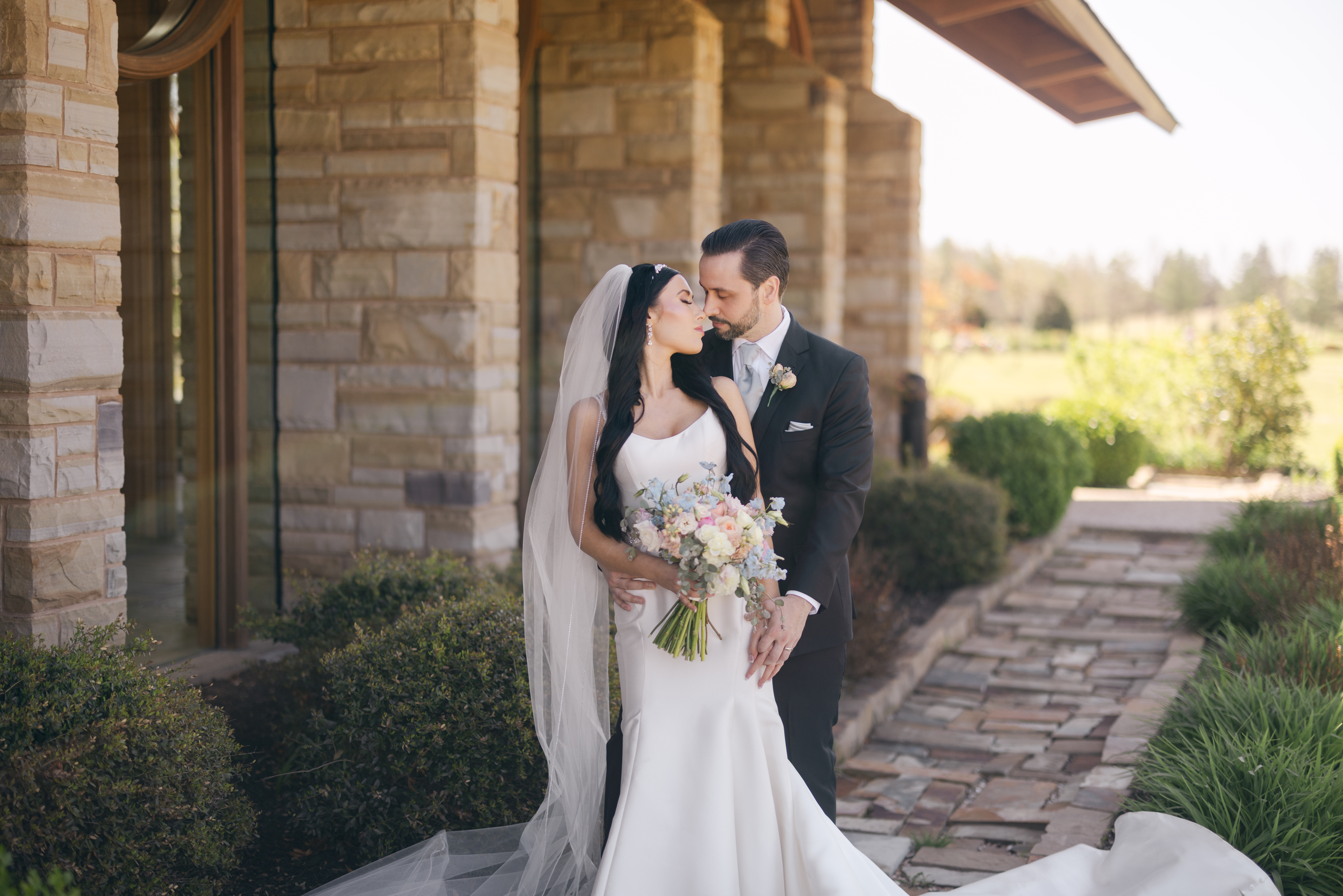 Bride and groom portraits outside Hunt Chapel Rogers Arkansas spring wedding tulips