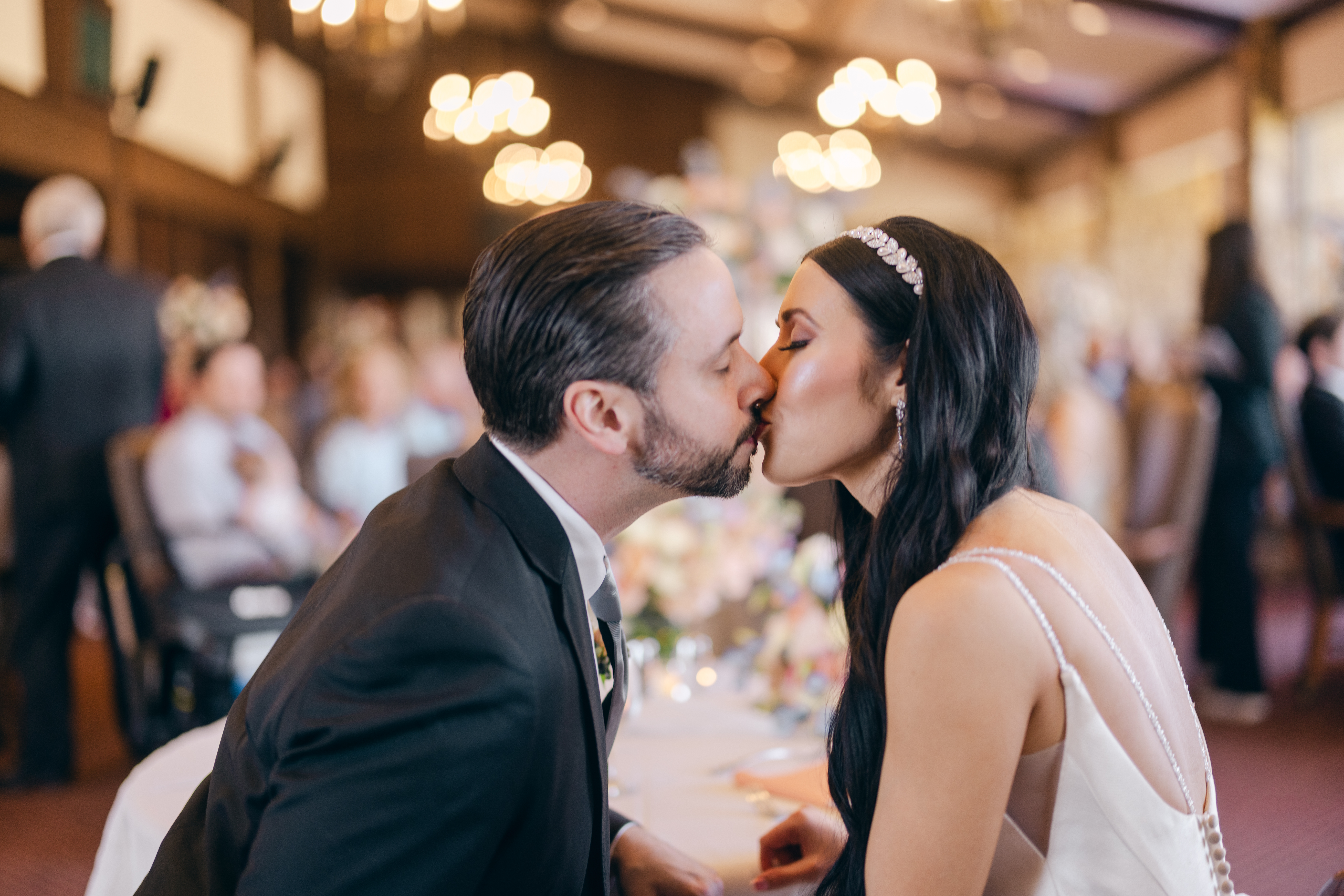 couple kiss at their Pinnacle Hills Country Club wedding in Rogers