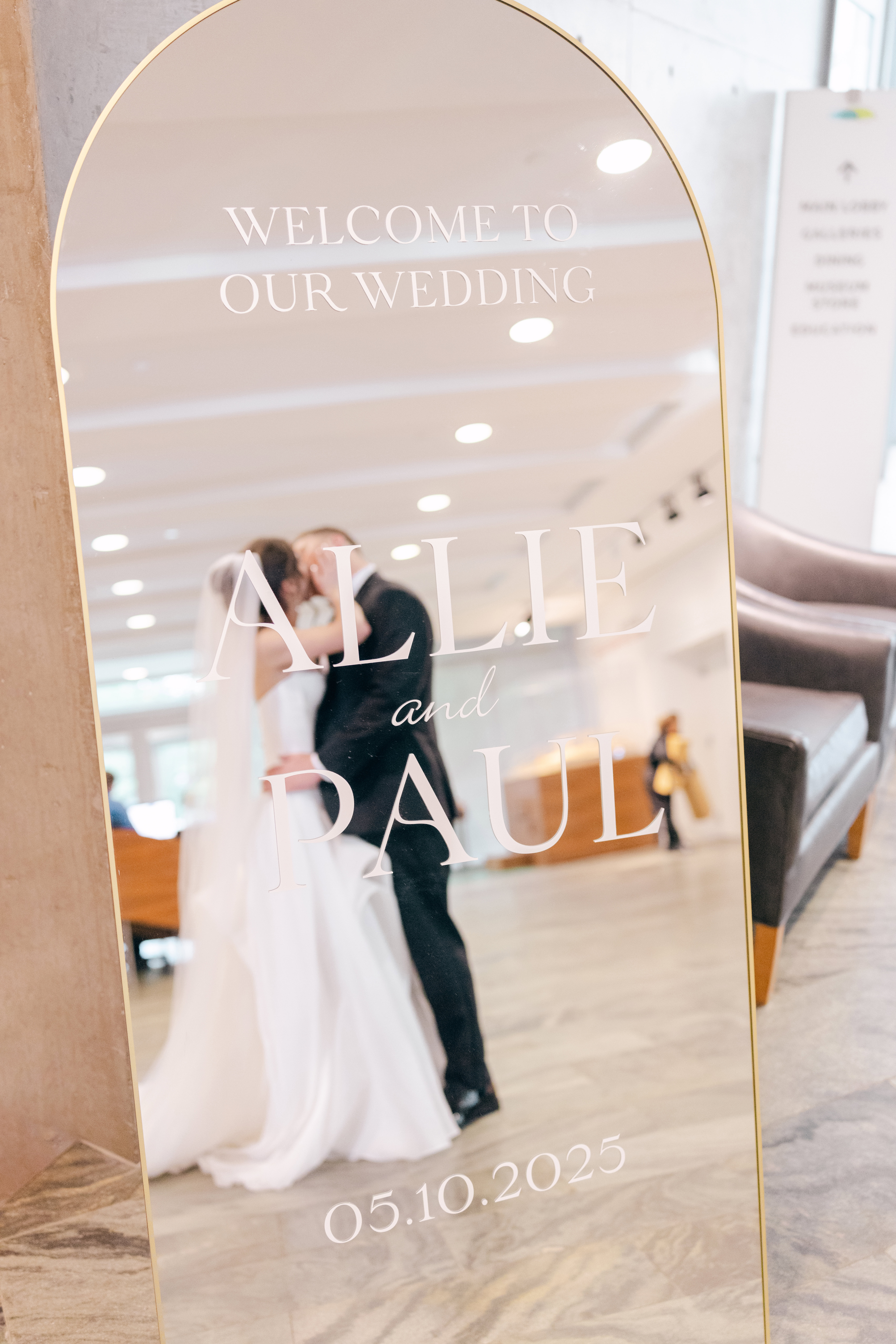 Reflection of a bride and groom at their Wedding at Crystal Bridges in a mirror.
