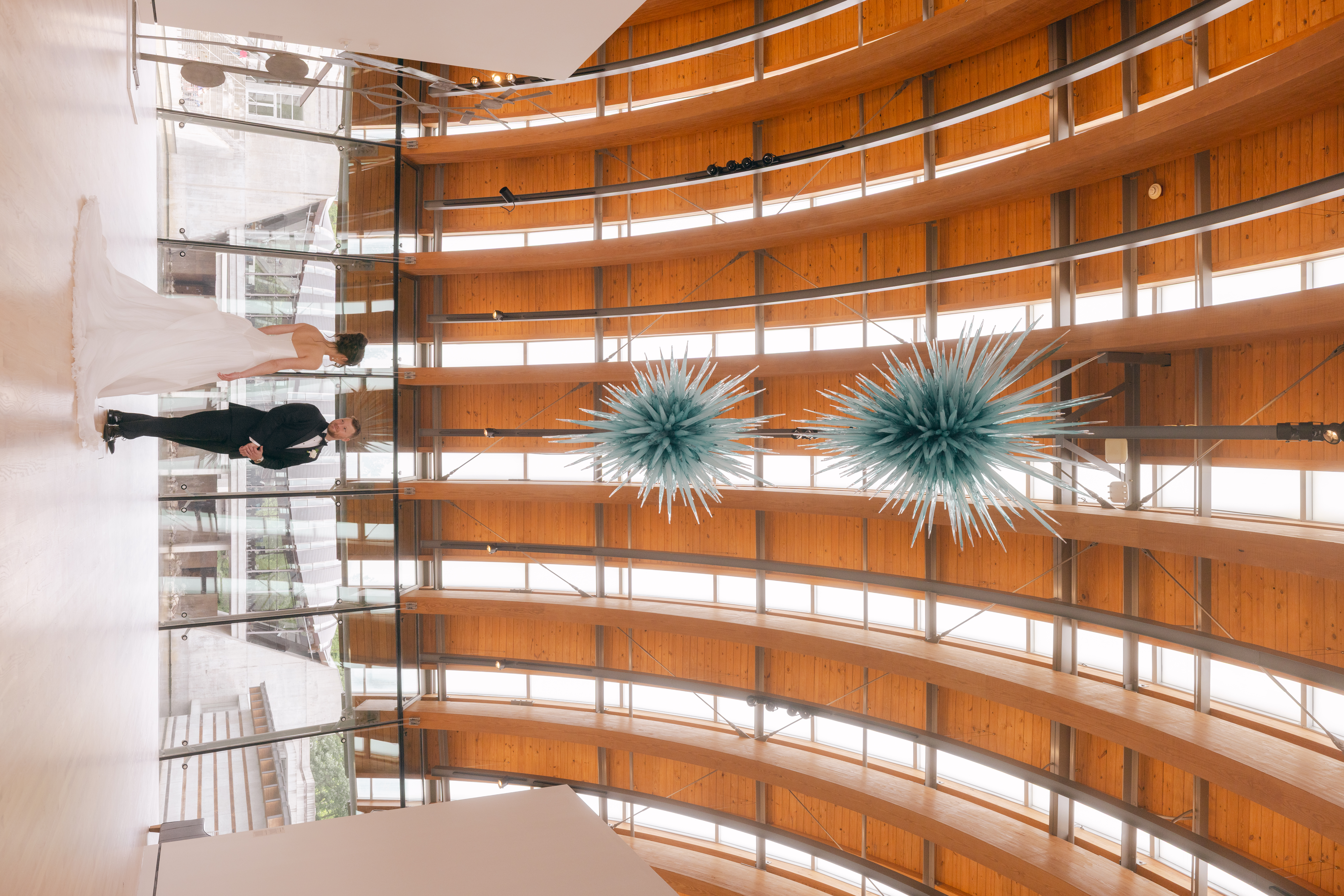First look of the bride and groom at their Crystal Bridges wedding under the blue chandelier