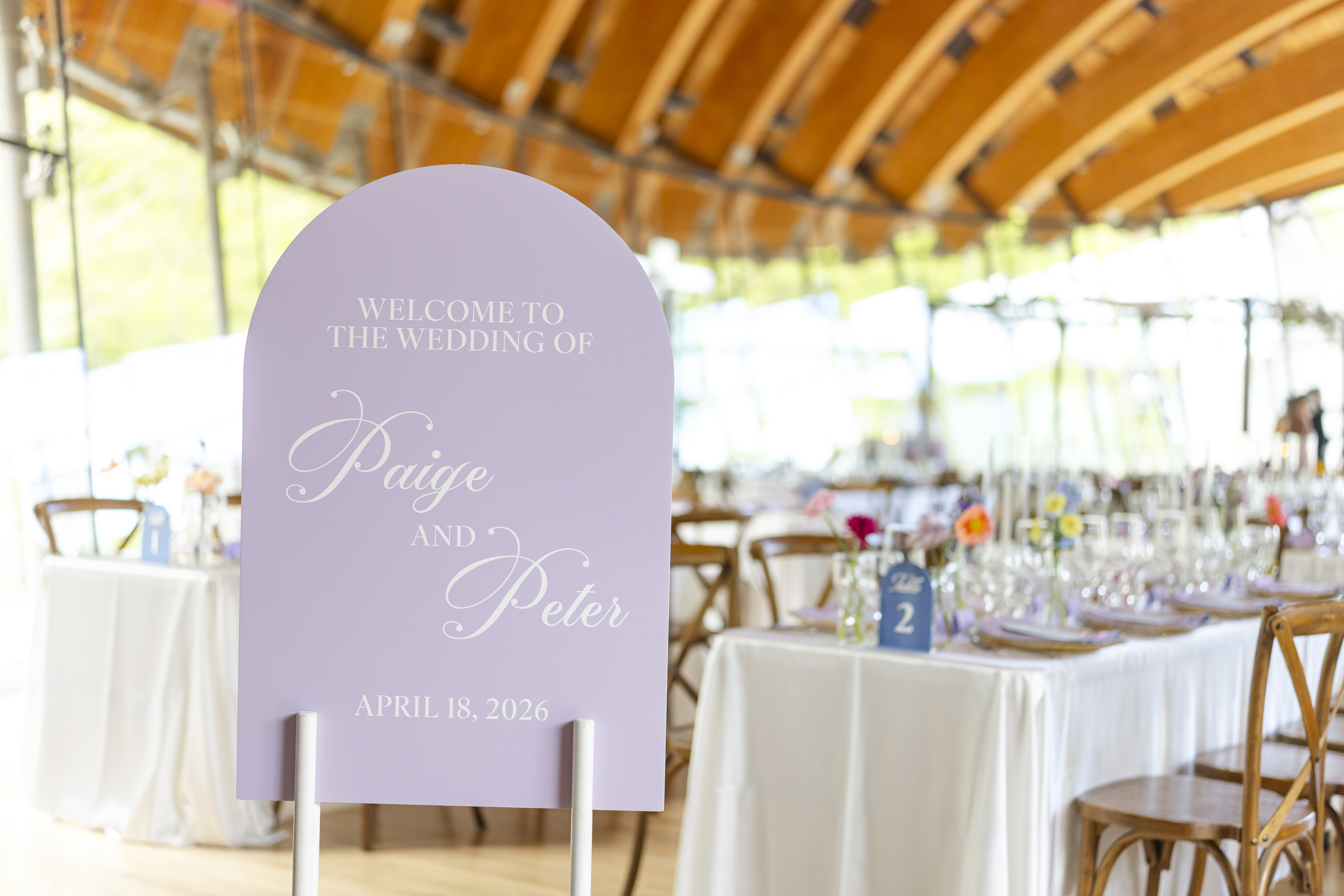 Crystal Bridges wedding welcome sign with bride and groom names in Great Hall reception space