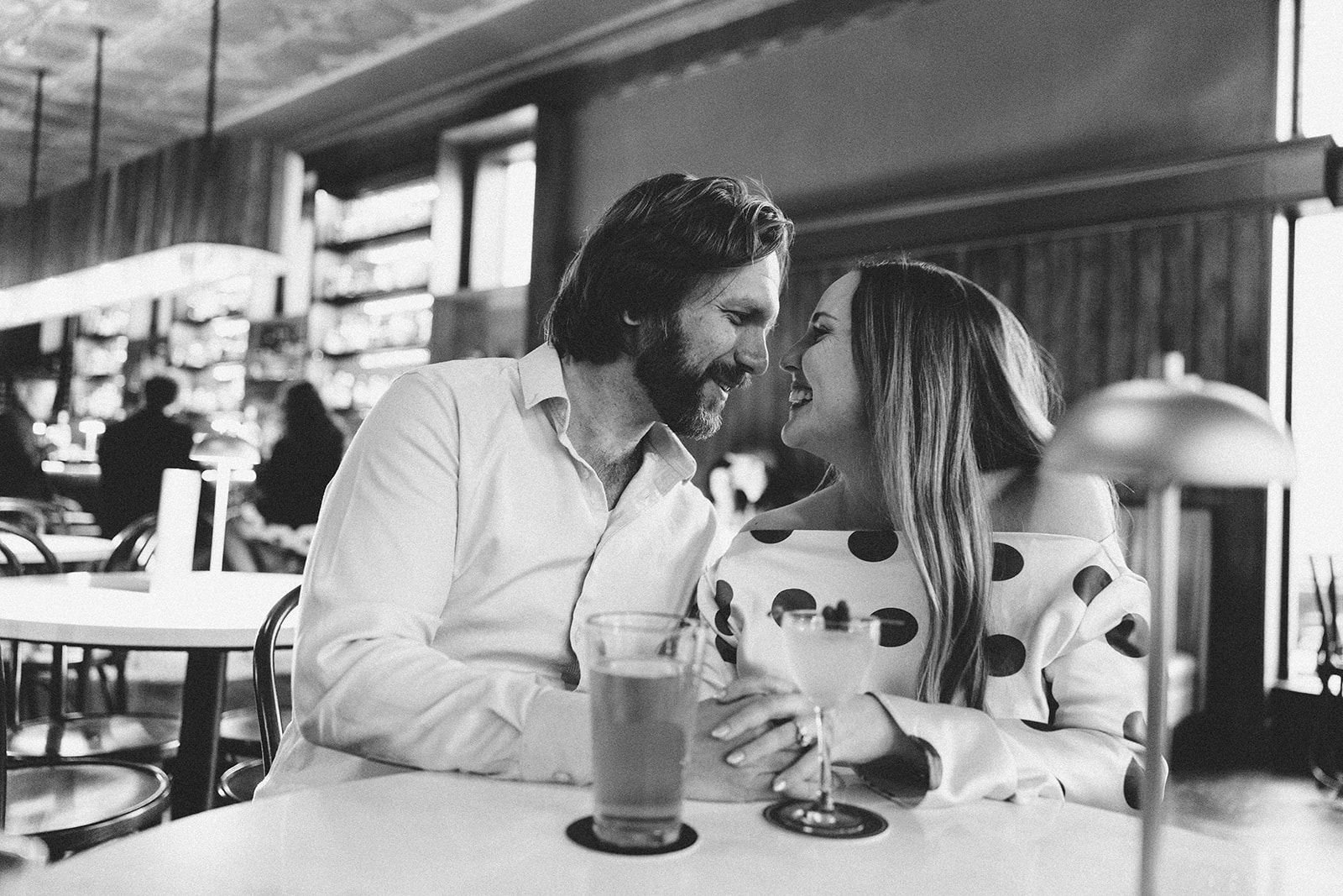 Engagement photos at Guisinger Bar in Fayetteville Arkansas black and white couple at bar