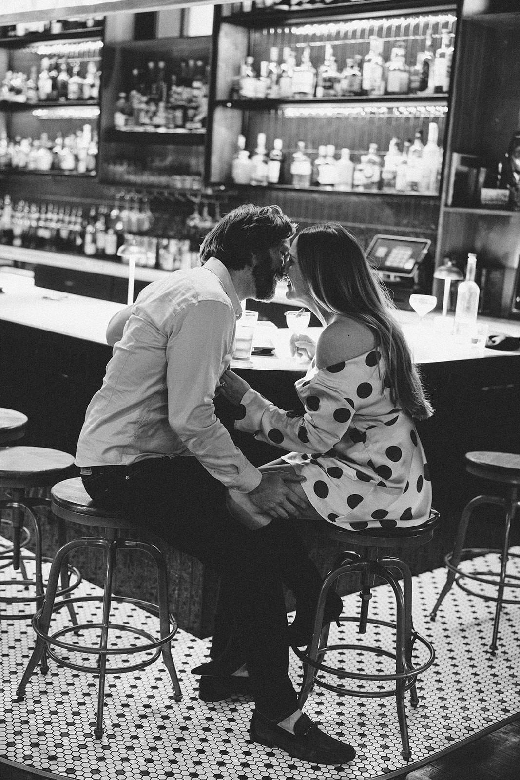 Engagement shoot at Guisingers in Fayetteville, where the couple sits at the bar
