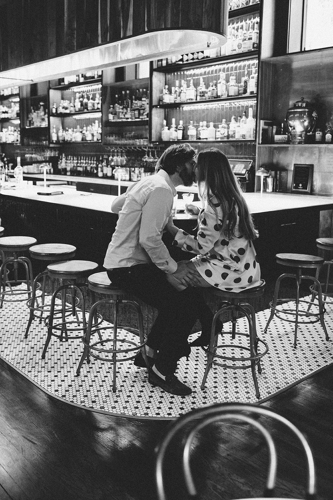 Engagement photos at Guisinger Bar in Fayetteville Arkansas black and white couple at bar