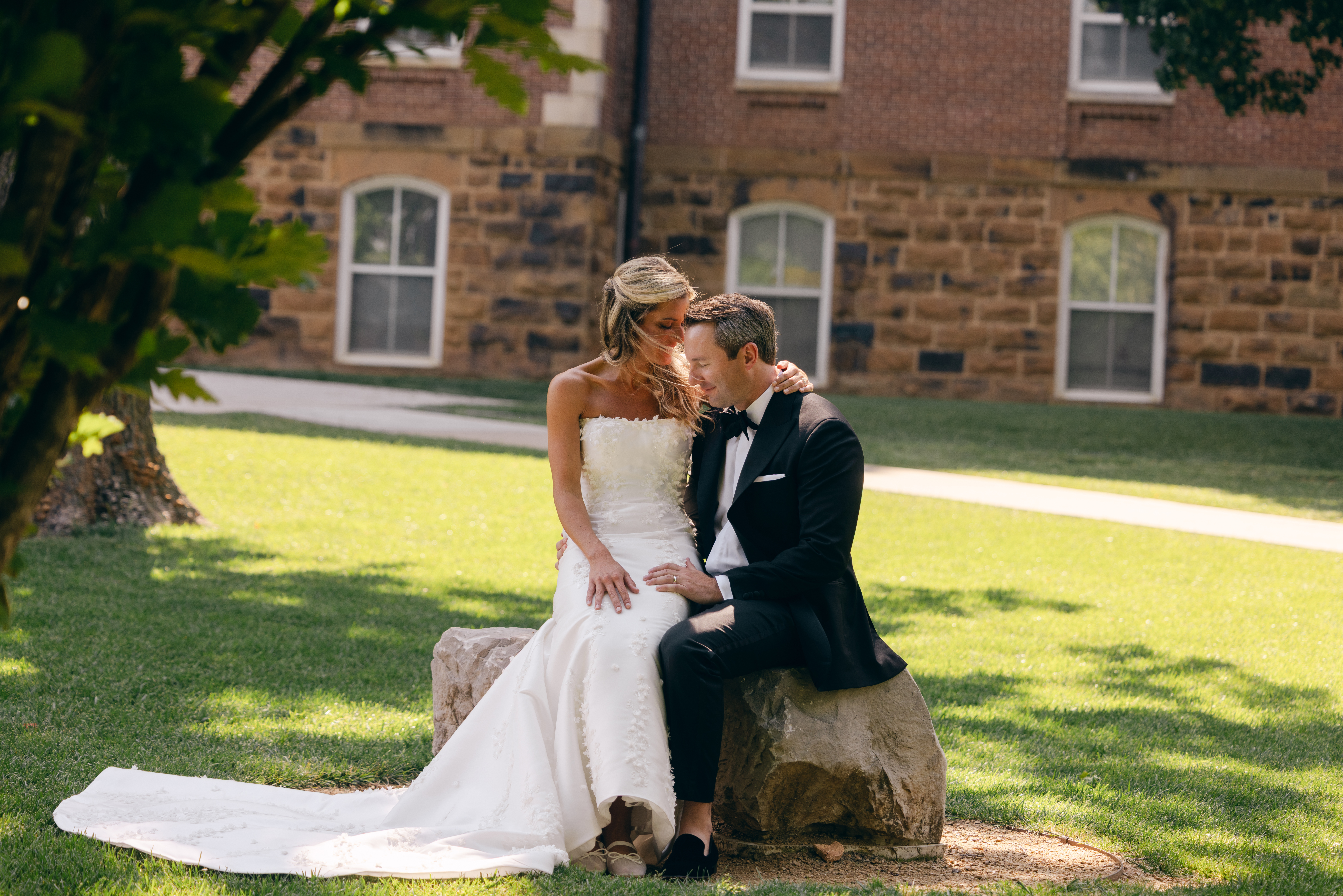 Bride and groom seated together at Old Main wedding portraits