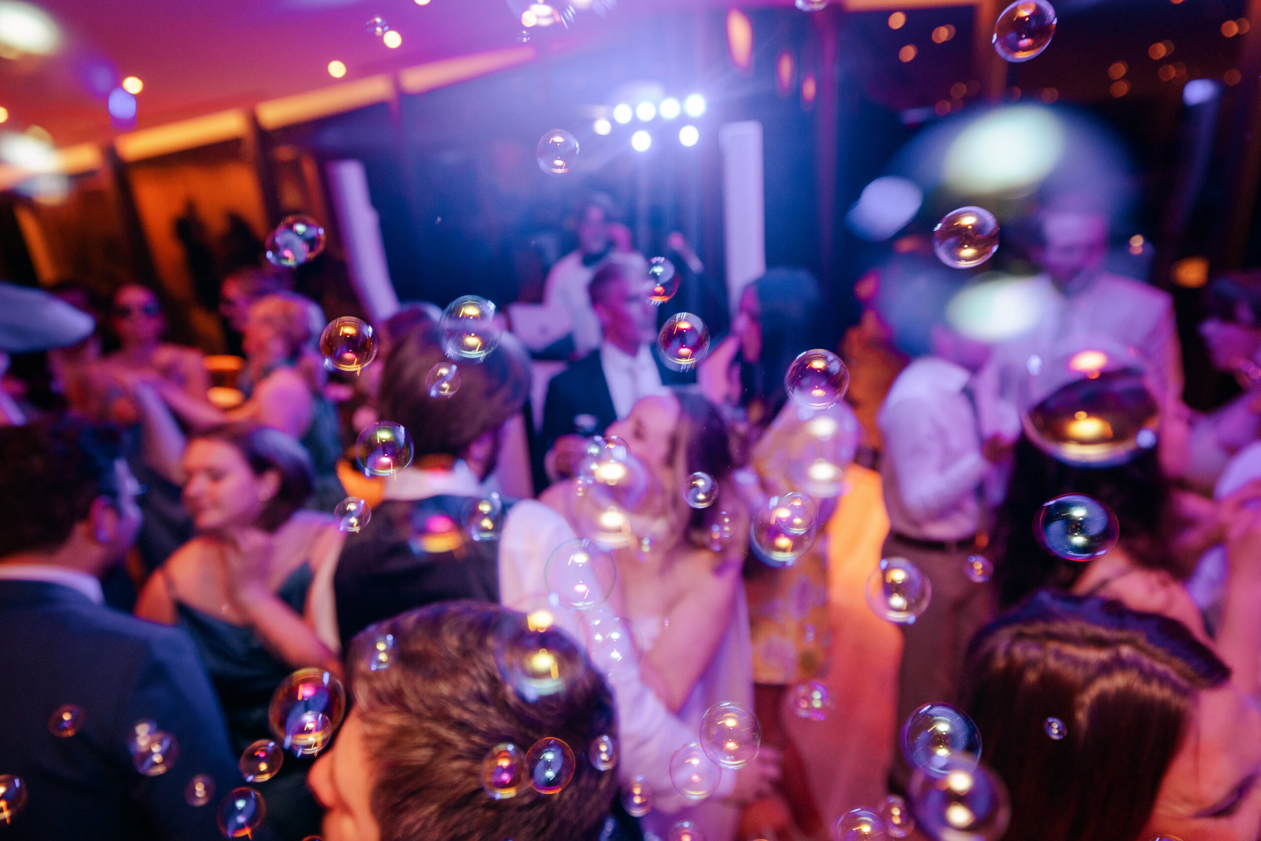 Wedding dance floor with bubbles and colorful lighting at Compton Gardens reception