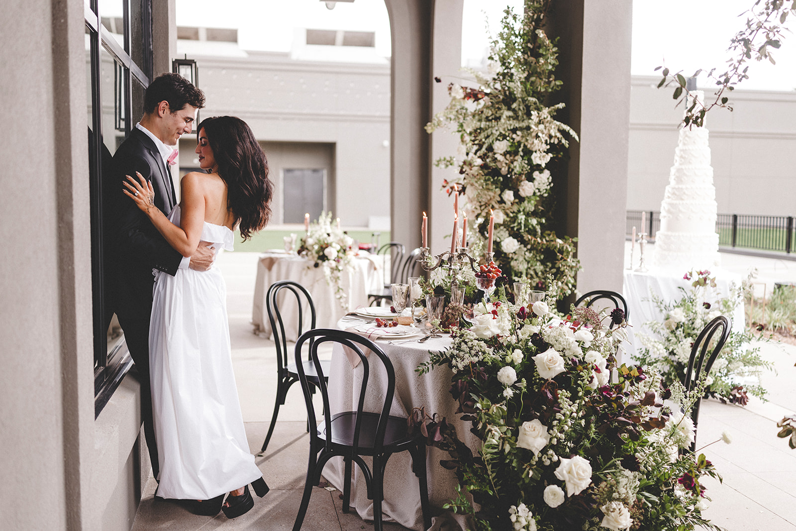 Luxury floral wedding reception setup with towering cake at Hotel Vin Rogers.