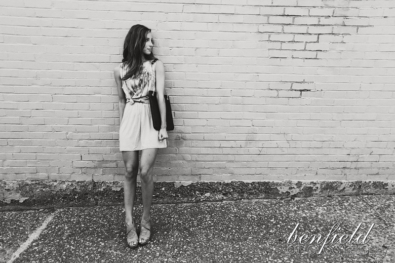 riffraff boutique photographer shoots a model against a brick wall in black and white
