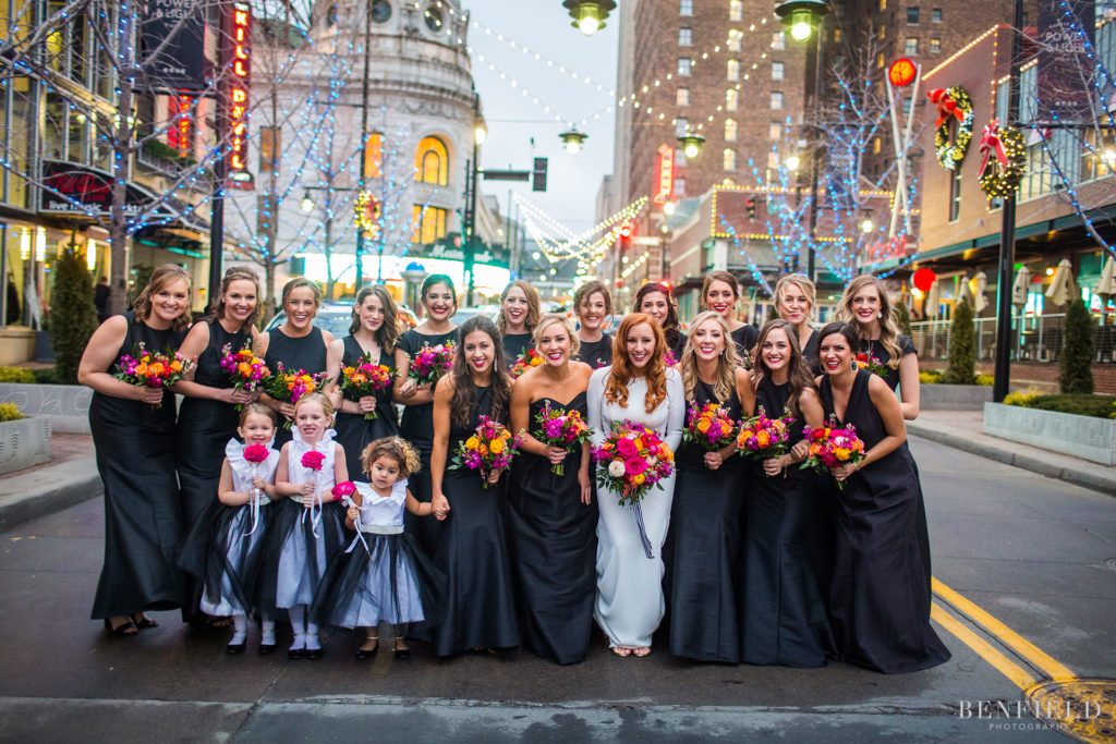 a huge wedding party group shot in the streets of kansas city power and light district on new years eve