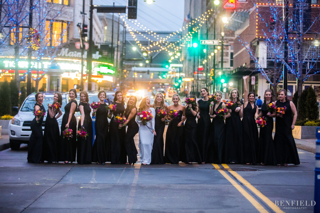 a huge wedding party group shot in the streets of kansas city power and light district on new years eve