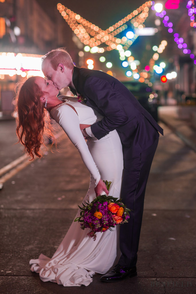 Christmas wedding portrait of bride and groom outside the Gallery Event Space in Kansas City in the power and light district on new years eve.