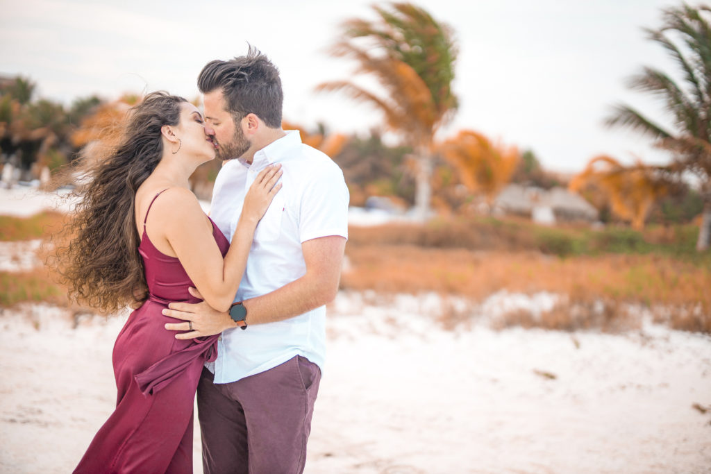 couple on honeymoon kissing at sunset in Mexico at El Dorado Maroma by professional honeymoon photographer Dale Benfield