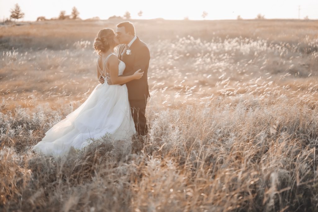 beautiful sunset portraits during golden hour with bride and groom