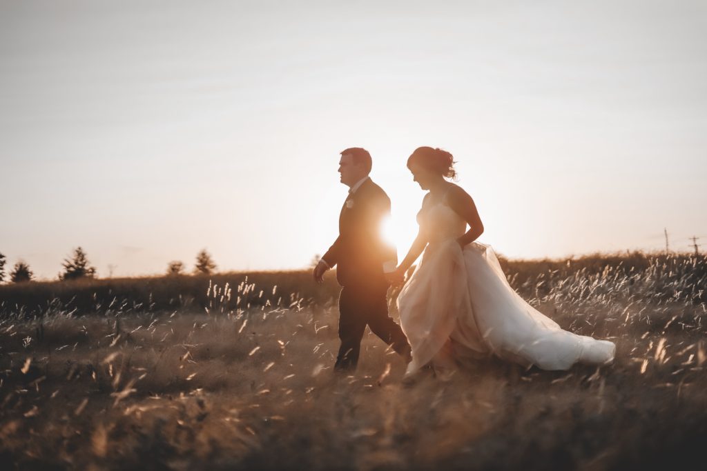 beautiful sunset portraits during golden hour with bride and groom