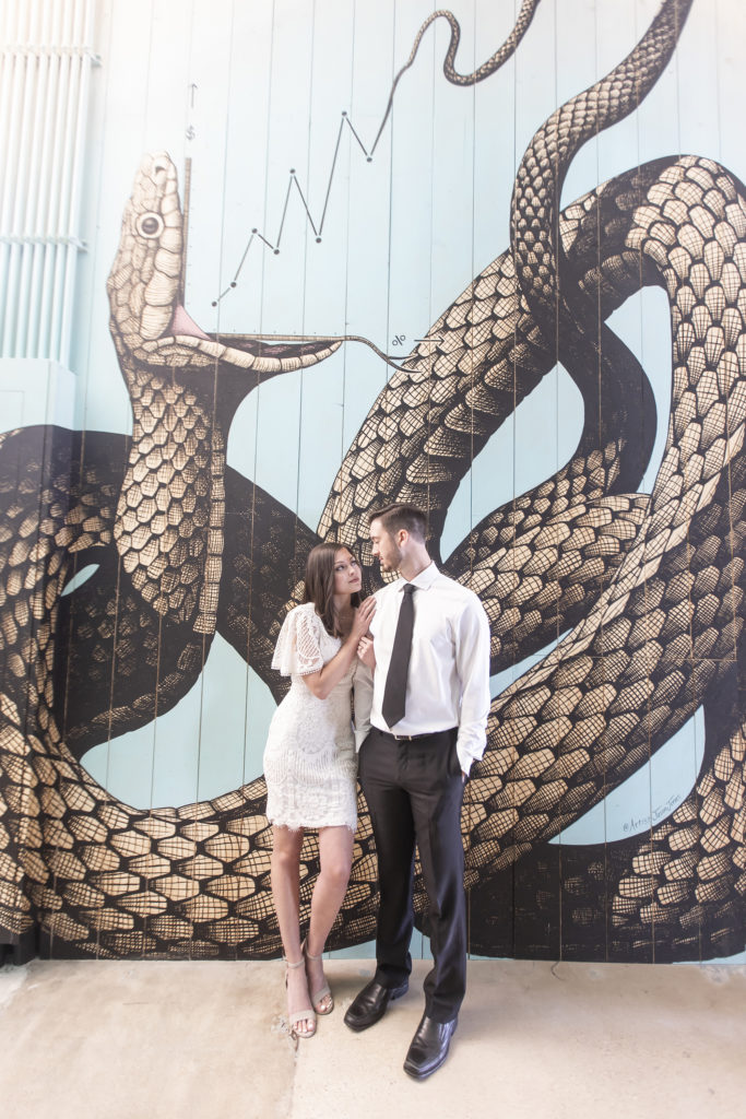 Wedding Reception at the 1907 portrait of the bride and groom in front of snake mural