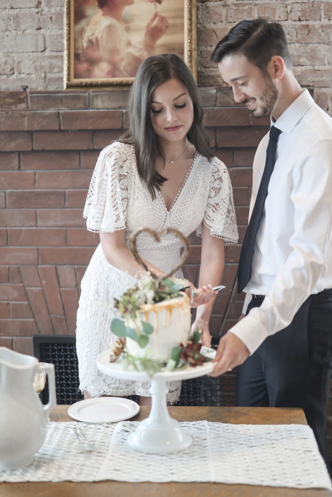 Wedding Reception at the 1907 with a boho wedding cake cut by bride and groom at onyx coffee lab
