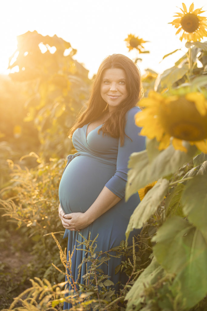 Amy Duggar maternity portraits in a sunflower field in Arkansas.