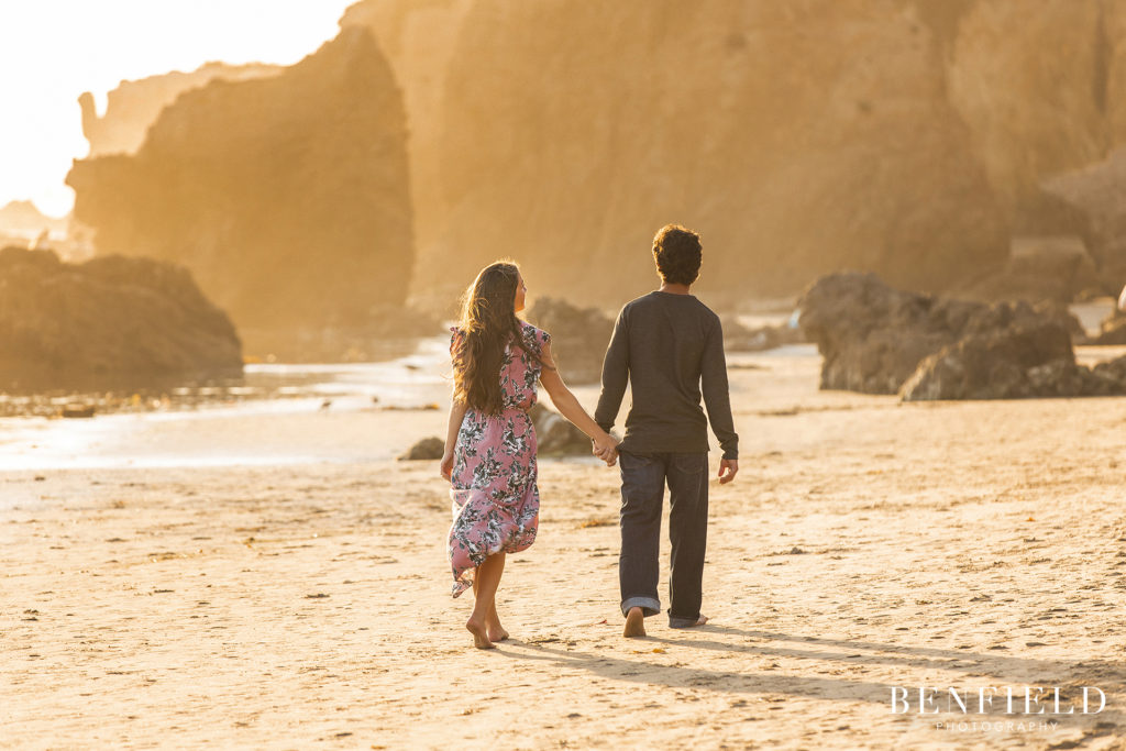 couple kissing at sunset on el matador beach for their engagement pictures