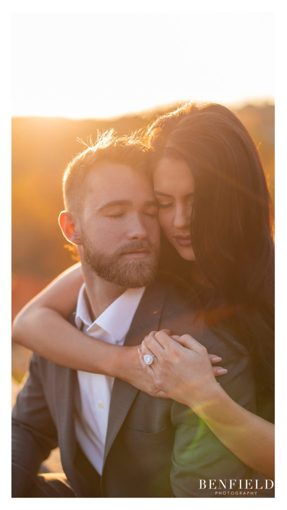 sunrise engagement pictures of the bride and groom hugging