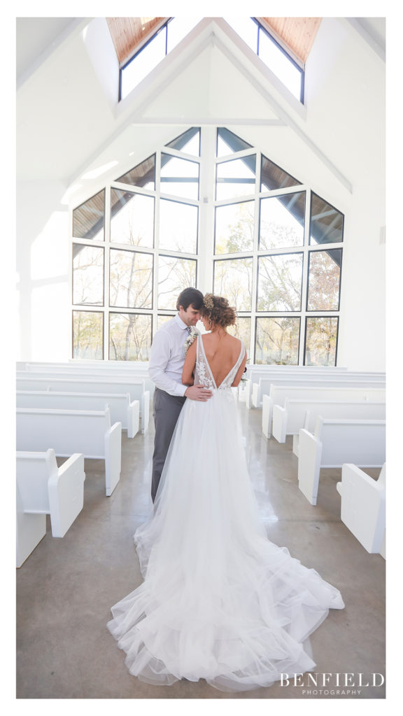 all white wedding chapel with bride and groom