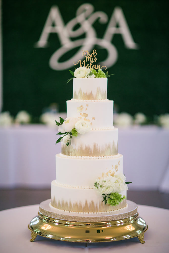 Gold brush strokes and decorative gold leaf make this 5-tier wedding cake a masterpiece in this Best Wedding Cake nominee.
