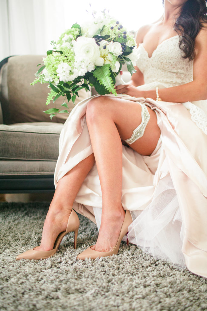 This green and white bridal bouquet is perfectly crafted. The bride holding it is showing off her style with the garter in this shot as well. This Best Bridal Bouquet is an obvious nominee.