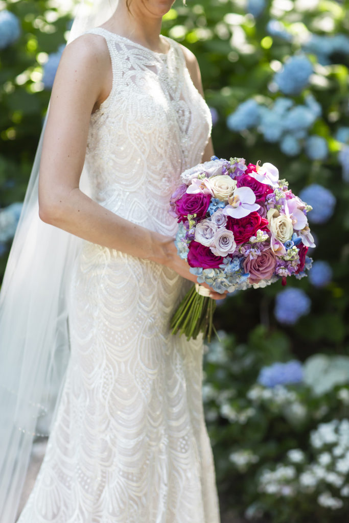 If you love color, this Best Bridal Portrait is for you! Colors of lavender, pink, blue, and yellow pop against the brides ornate, white wedding dress.