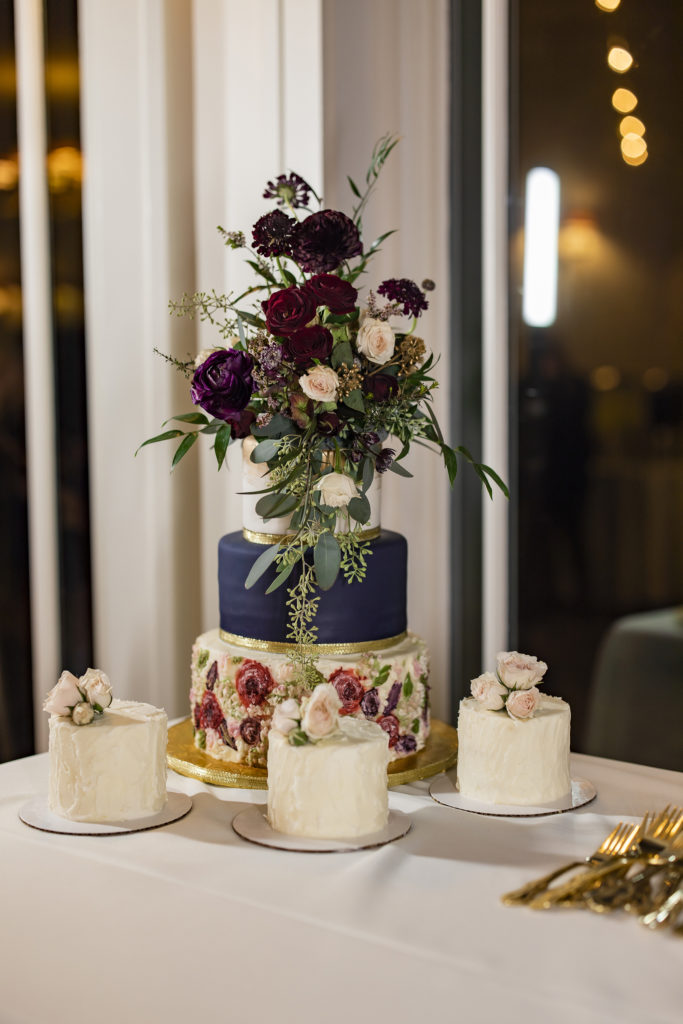 Rich navy and gold trim make this three tier cake unique. So does the three accompanying cakes. All fit together perfectly in this Best Wedding Cake nominee.