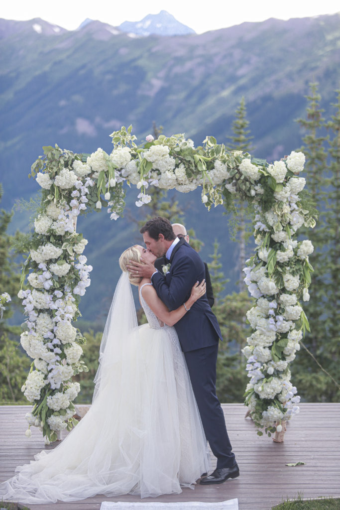 bride and groom first kiss on top of Aspen Mountain